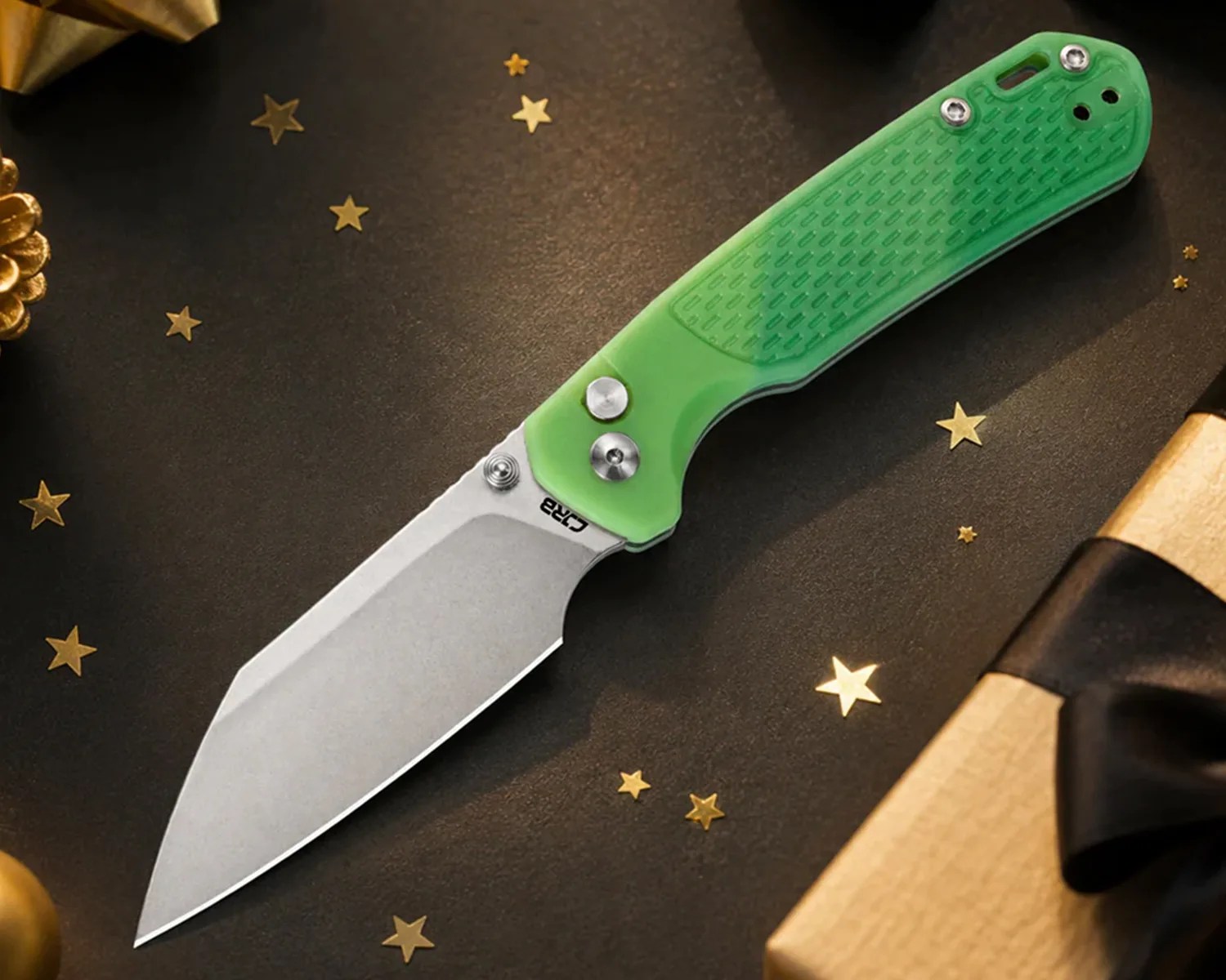 Folding knife with a stonewashed blade and translucent green textured handle on a dark surface with gold star confetti.
