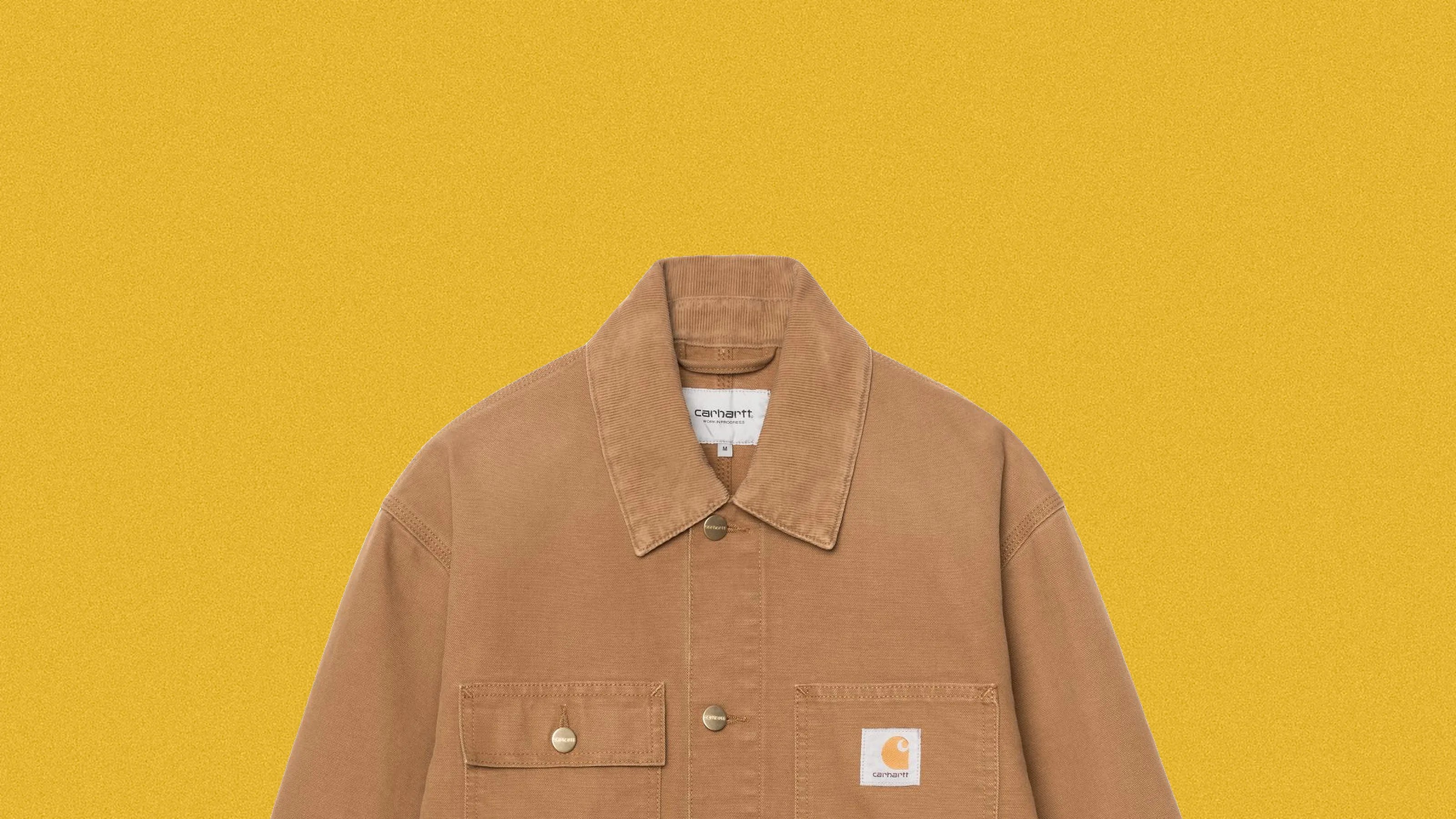 Brown Carhartt jacket with corduroy collar and front pockets on a yellow background.