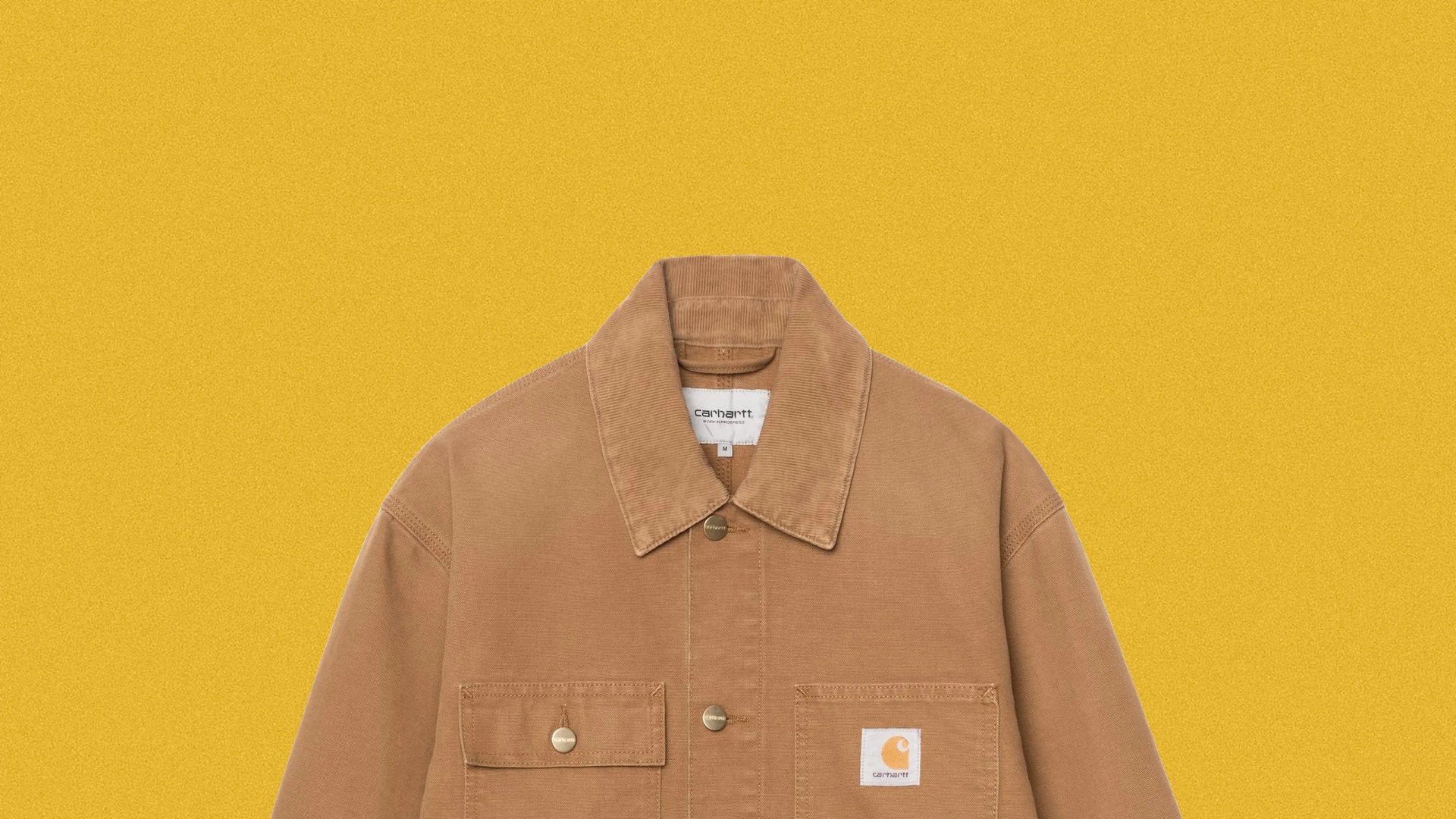 Brown Carhartt jacket with corduroy collar and front pockets on a yellow background.
