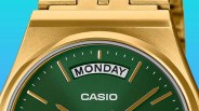 Close-up of a gold Casio watch with a green dial showing the day "Monday.