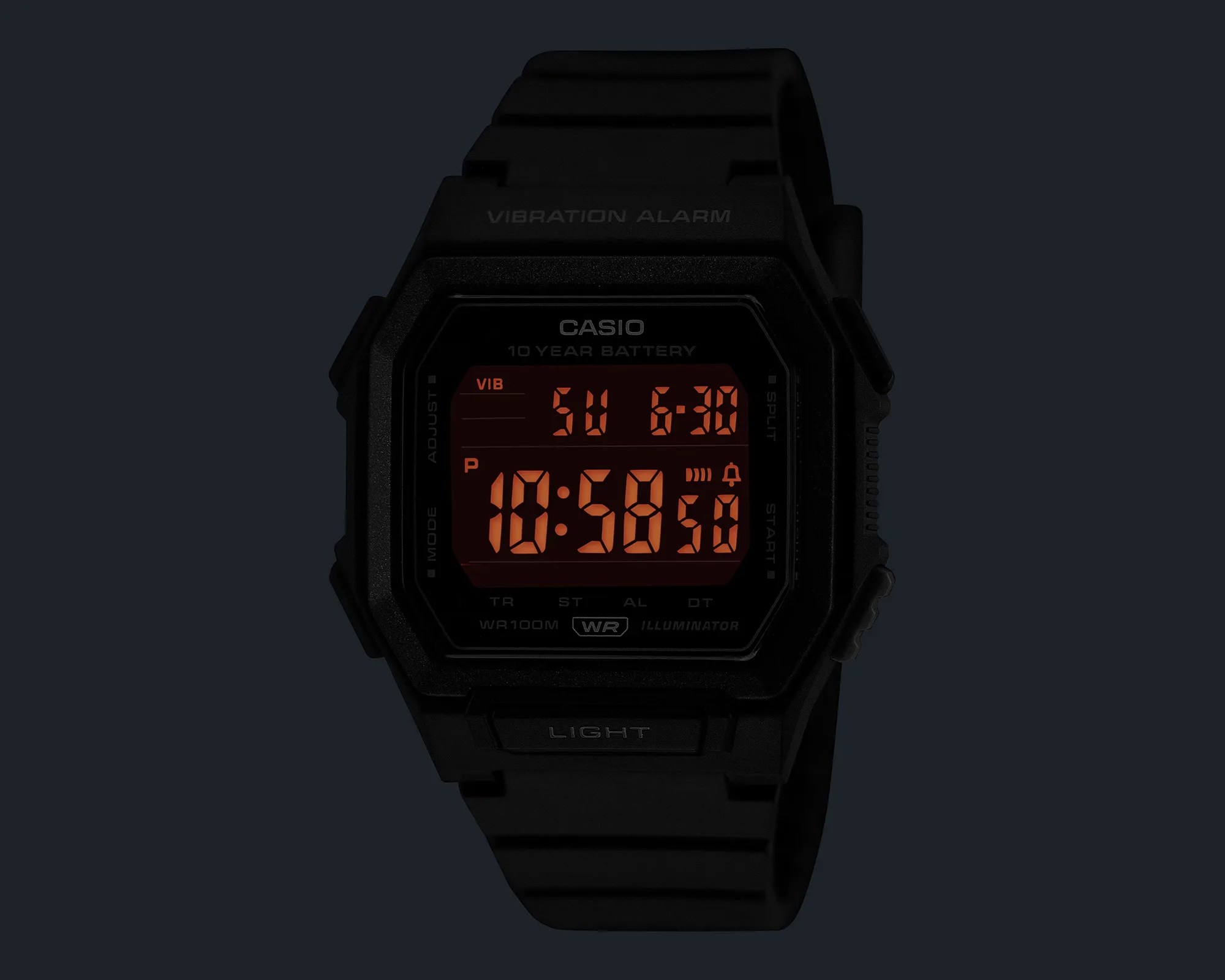 Black Casio digital wristwatch with red illuminated display showing time, date, and alarm icons.