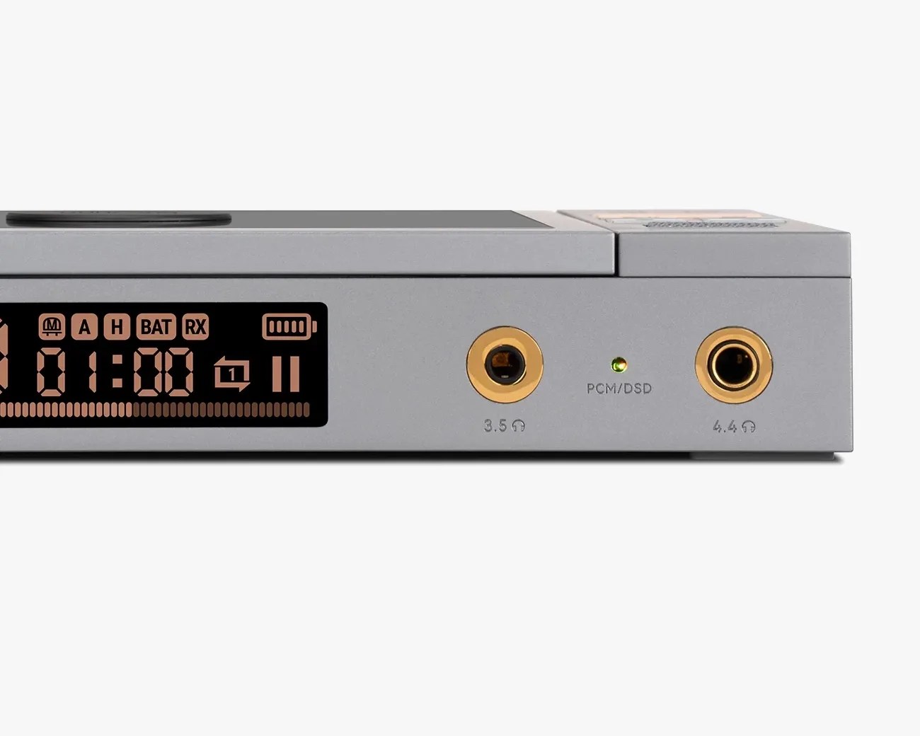 Close-up of a gray audio device front panel showing a digital display, 3.5mm and 4.4mm headphone jacks, and a green PCM/DSD indicator light.