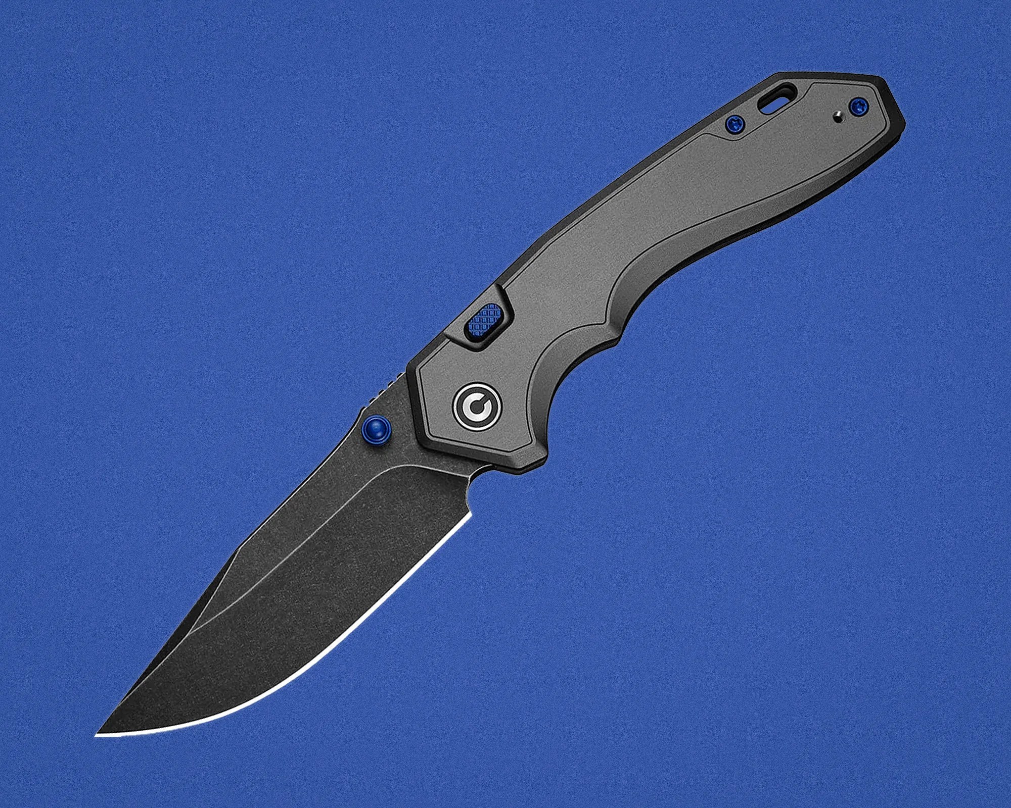 Black folding knife with textured handle and blue screws on a blue background.