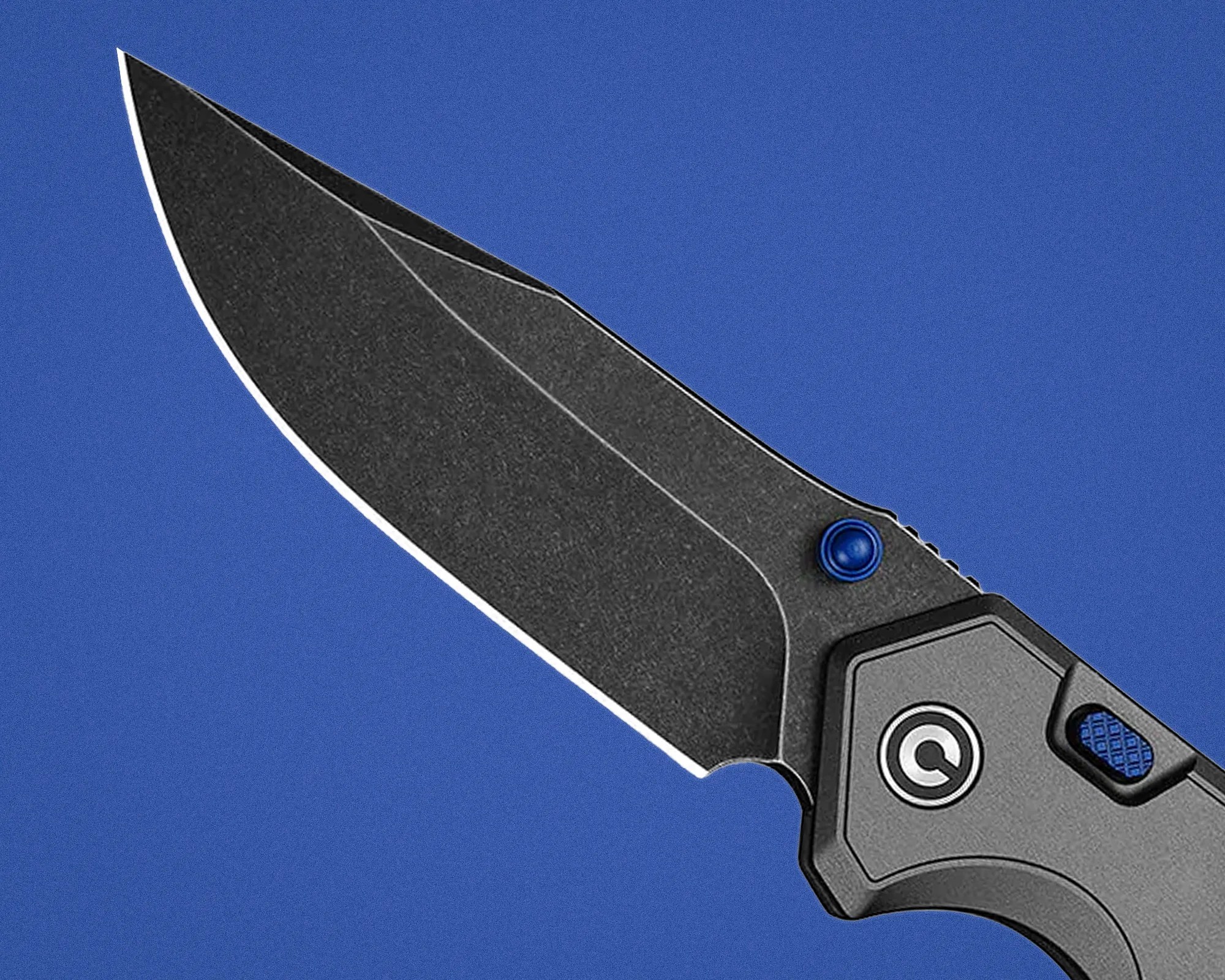 Black folding knife blade with a textured finish and blue thumb stud on a blue background.