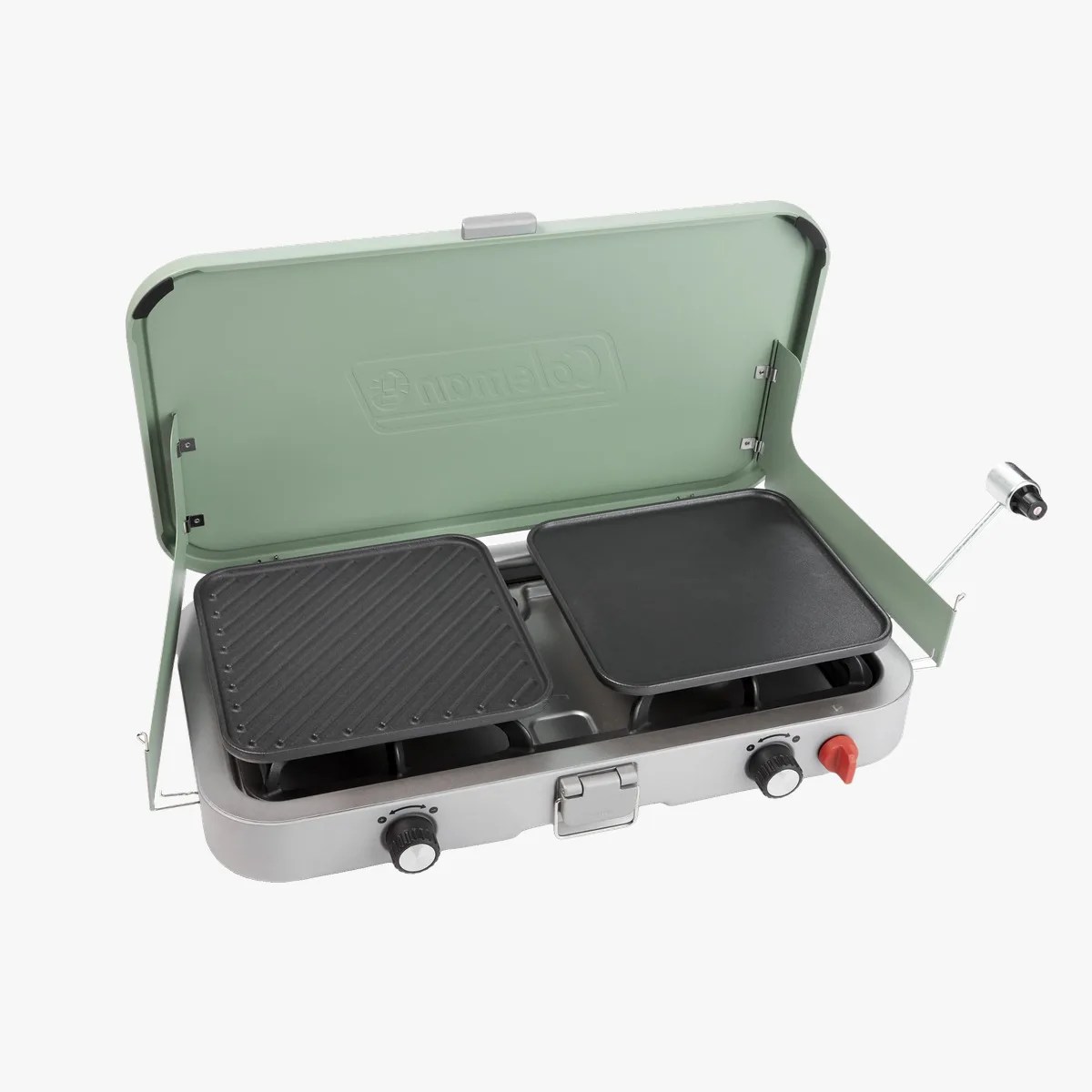 Portable green Coleman camping stove with two black cooking griddles and control knobs.