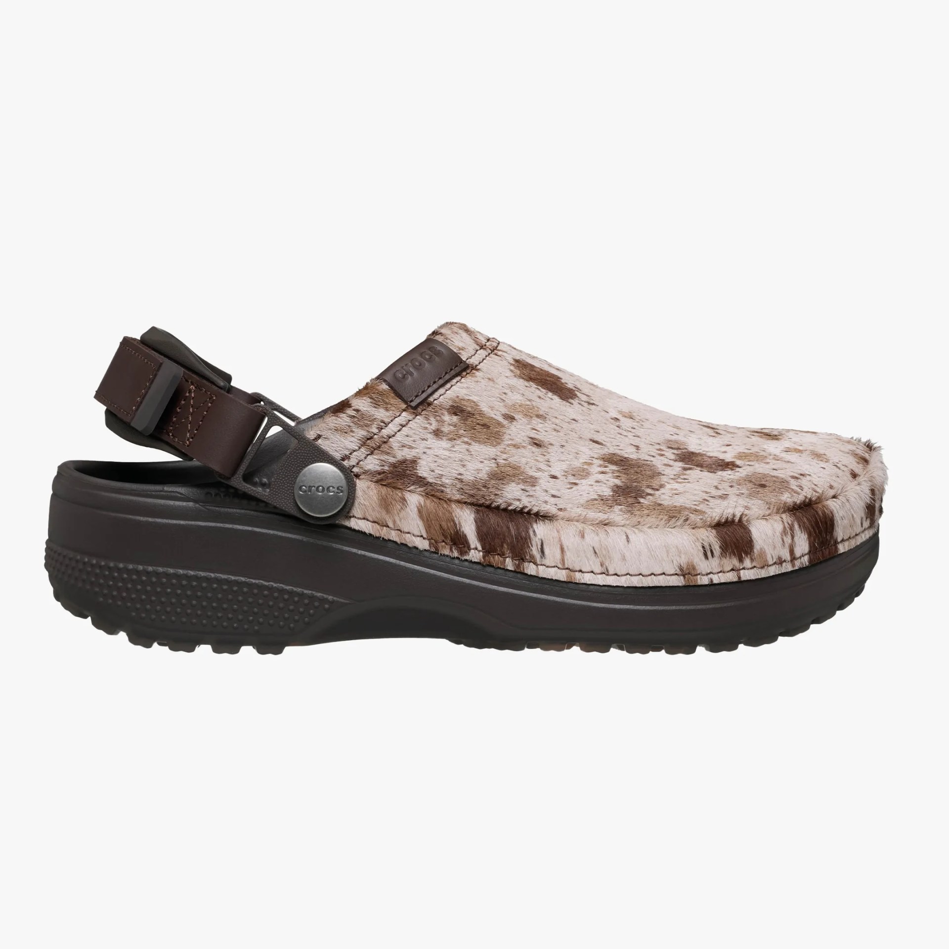 Brown and white speckled fur-textured Crocs clog with dark brown adjustable strap and sole.