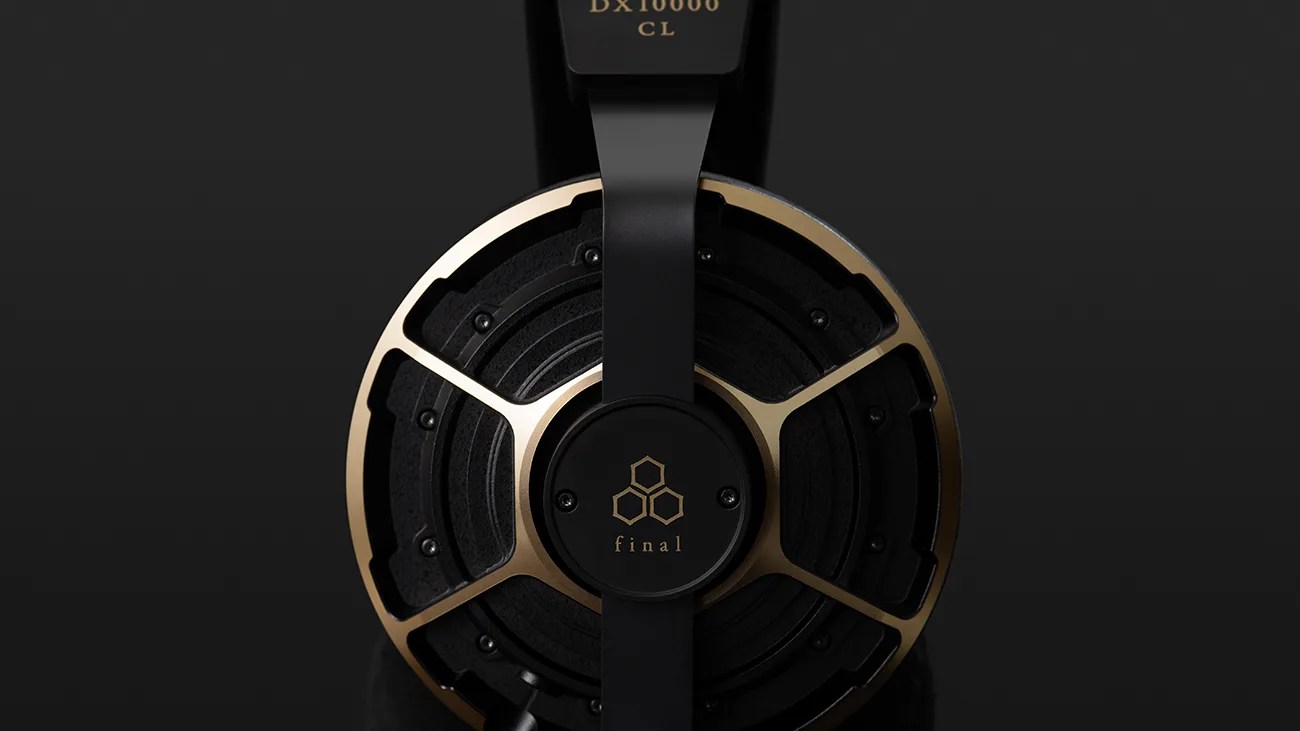 Close-up of a black and gold headphone ear cup with the brand name "final" on a dark background.
