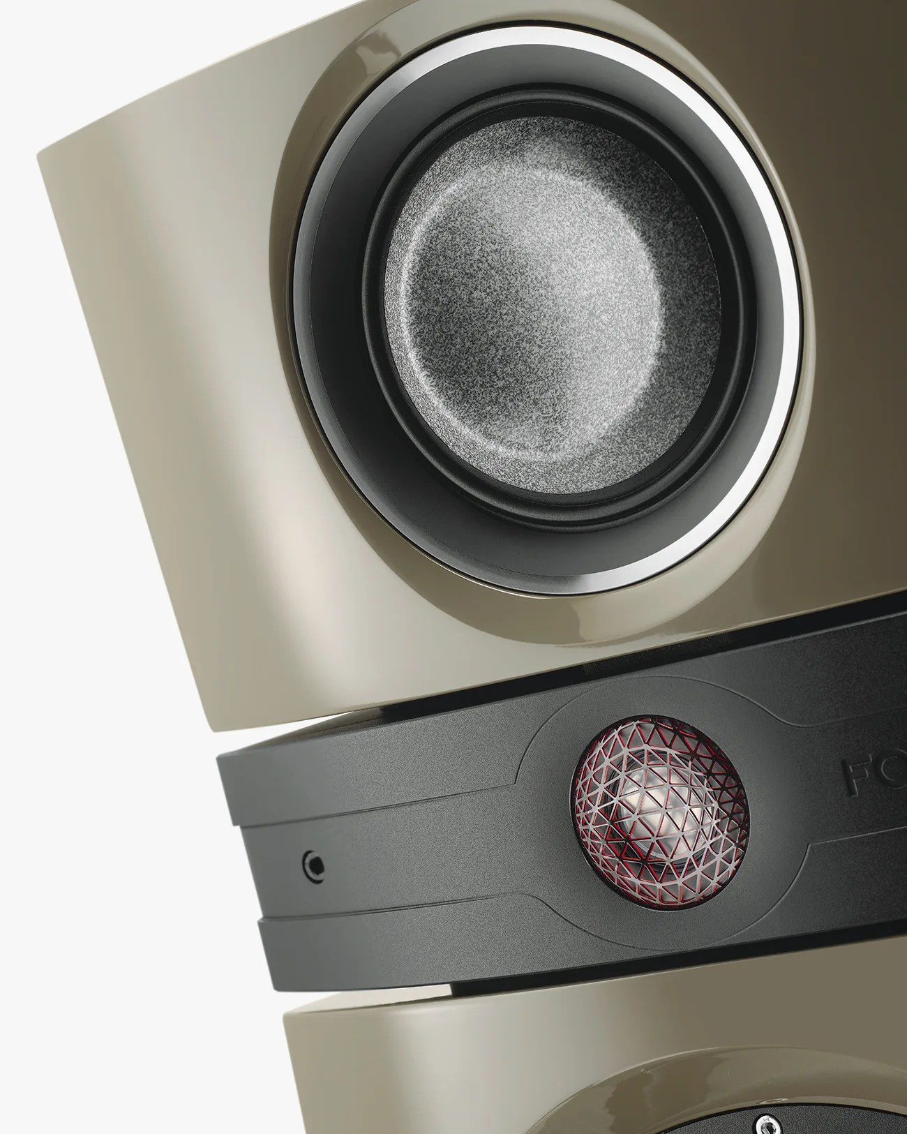 Close-up of a beige speaker with a textured gray cone and a black section featuring a red mesh-covered tweeter.