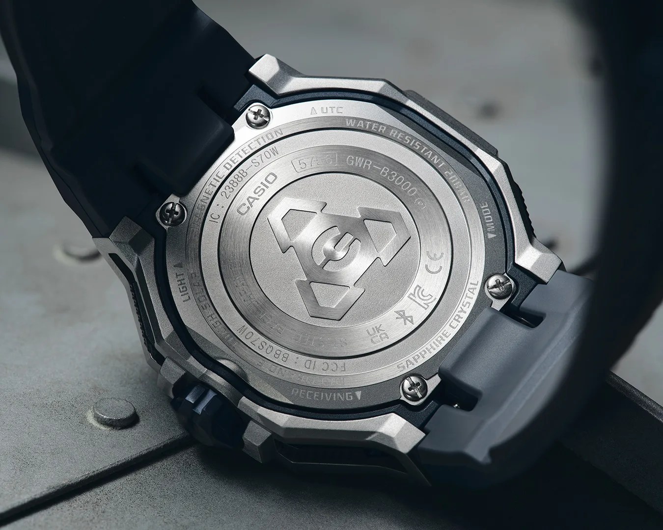 Back of a Casio G-Shock watch with metal case back and black resin strap.