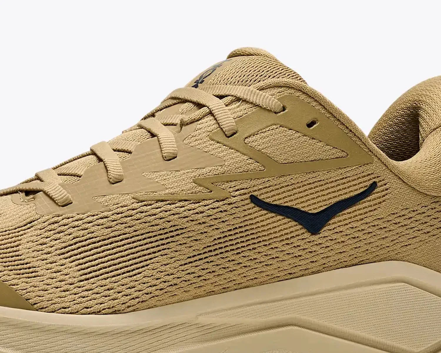 Tan mesh athletic shoe with beige synthetic overlays and a black logo on the side.
