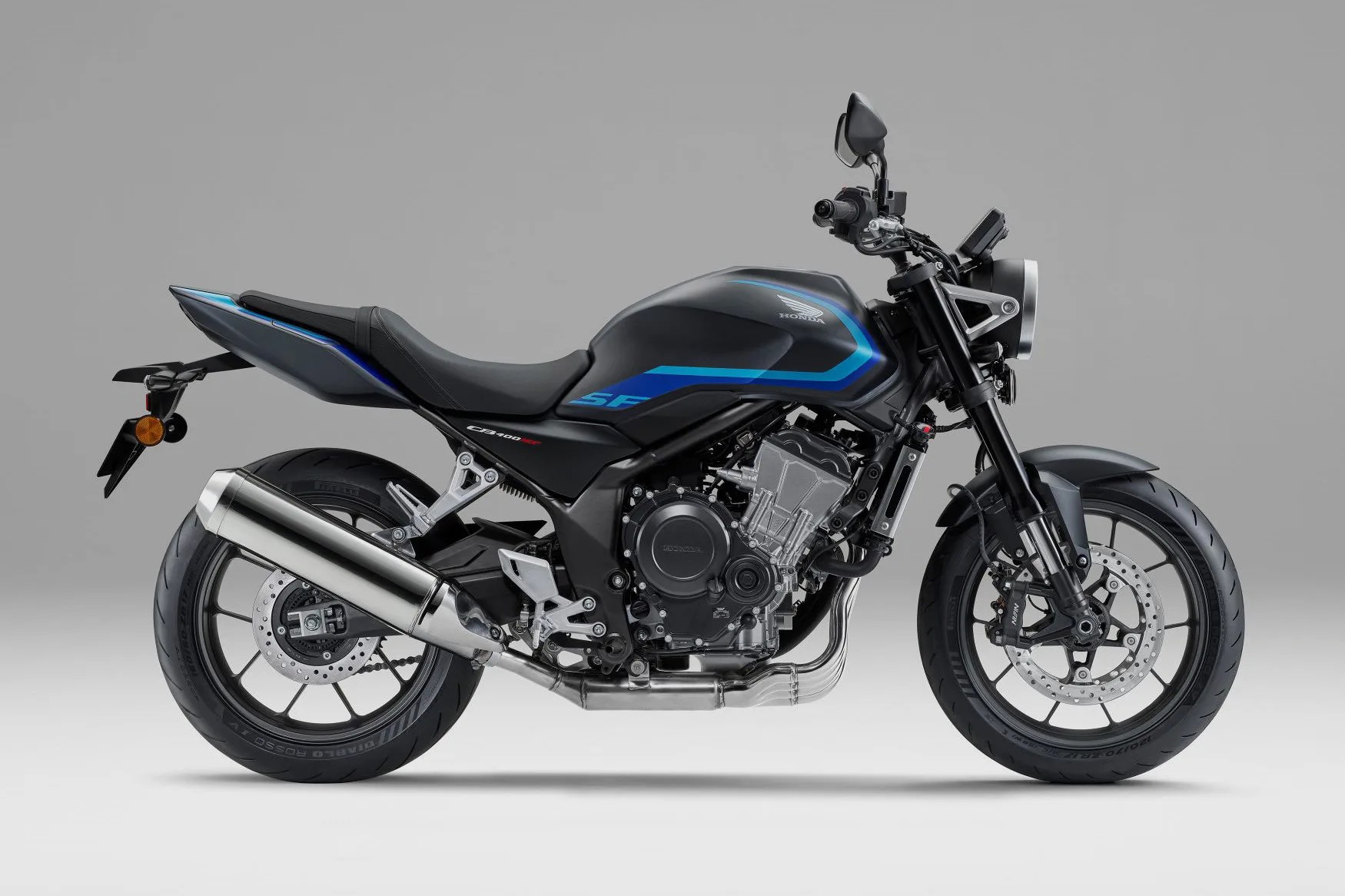 Matte black Honda CB400SF motorcycle with blue accents and silver exhaust on a gray background.