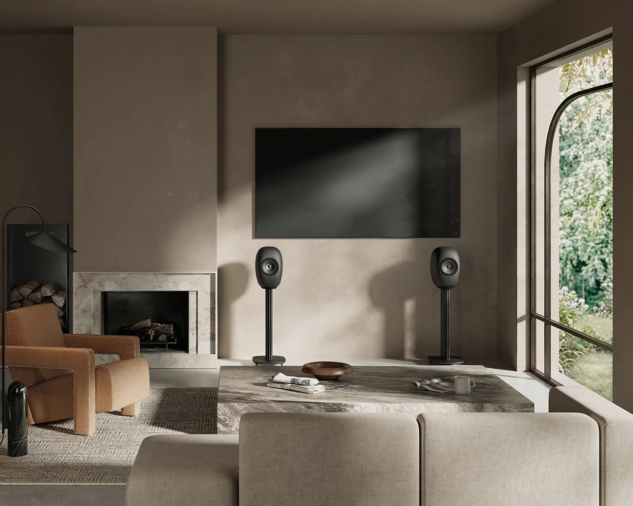 Modern living room with beige sofa, brown armchair, marble coffee table, black speakers on stands, and large window.