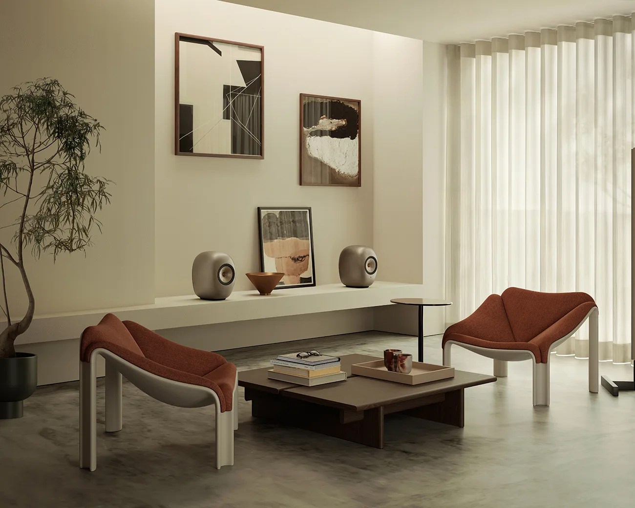 Minimalist living room with two rust-colored lounge chairs, low dark wood coffee table, and abstract art on a beige wall.