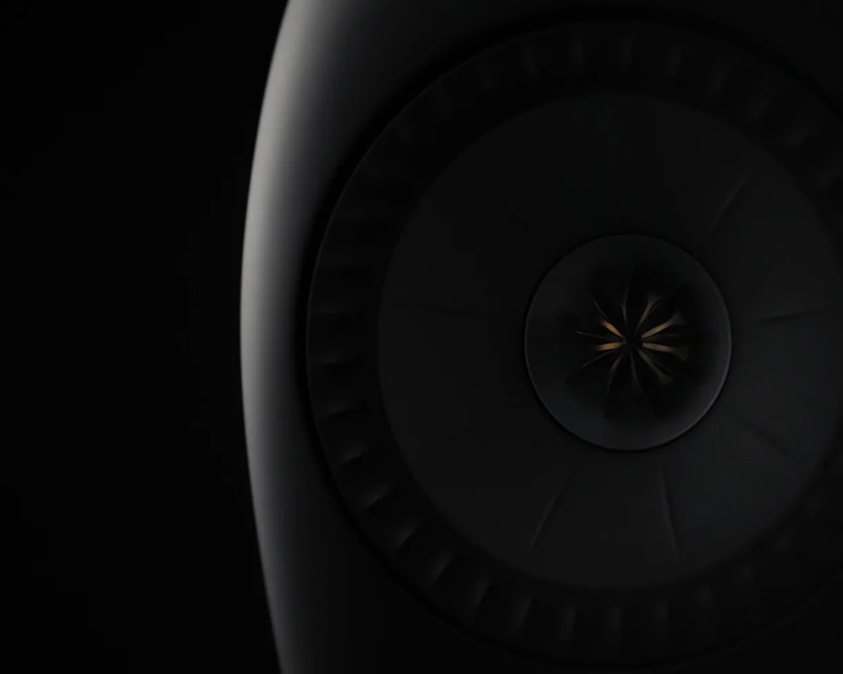 Close-up of a dark, circular turbine or fan blade with subtle lighting highlighting its curved edges.