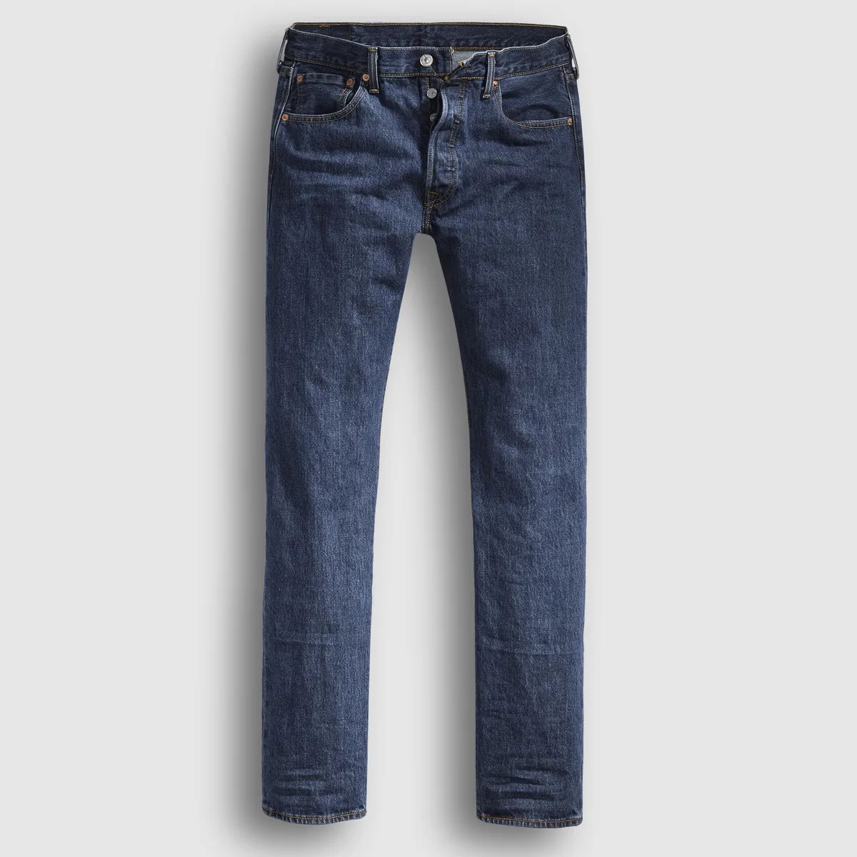 Dark blue straight-leg denim jeans with button fly and five-pocket design laid flat on a light background.