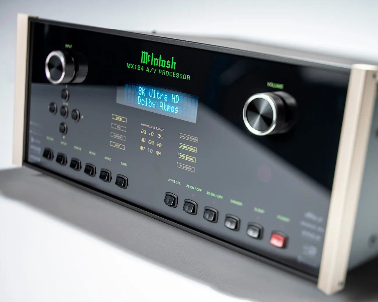 Black McIntosh MX124 A/V processor with green text and multiple buttons on a gray surface.
