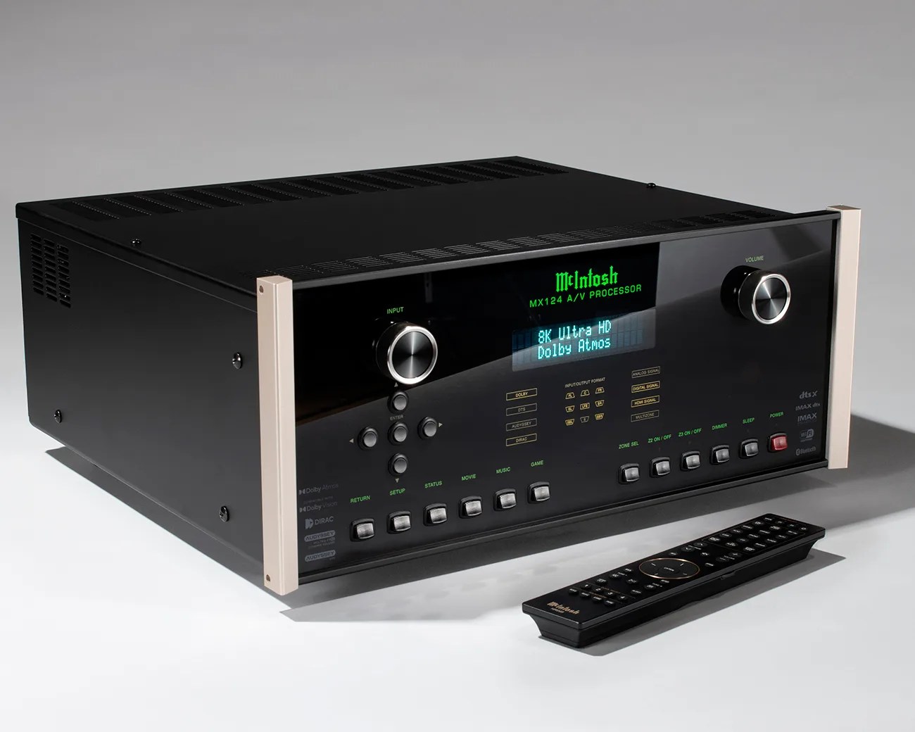 Black McIntosh MX124 A/V processor with green digital display and silver side panels, accompanied by a black remote control.