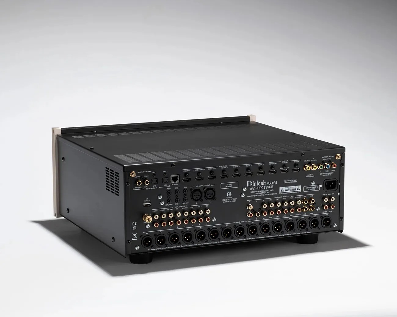 Black McIntosh MX124 A/V processor with multiple audio and video input/output ports on a white surface.