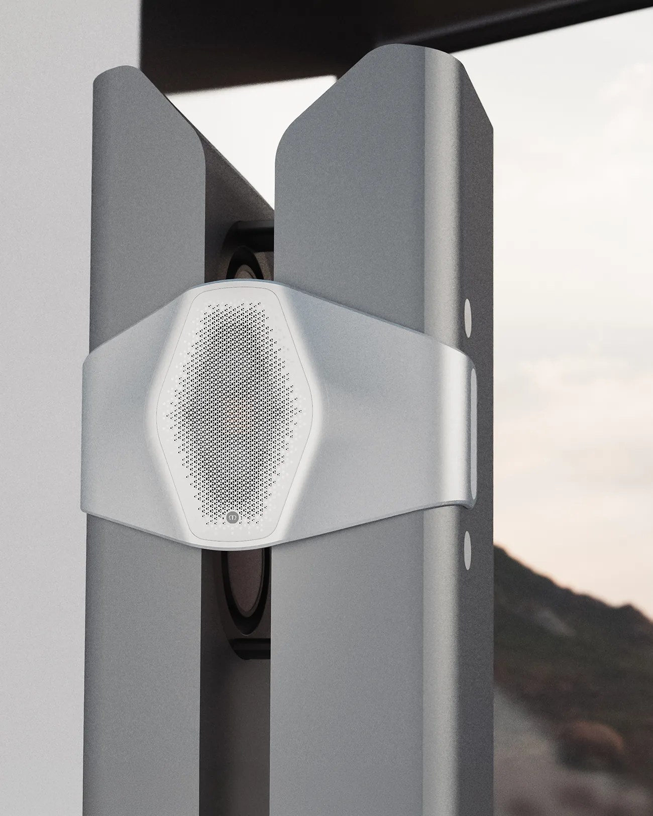 Silver hexagonal speaker with perforated grille mounted on a vertical gray metal structure outdoors.