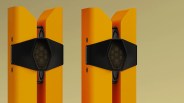 Pair of tall, orange speakers with black hexagonal mesh covers on a beige background.