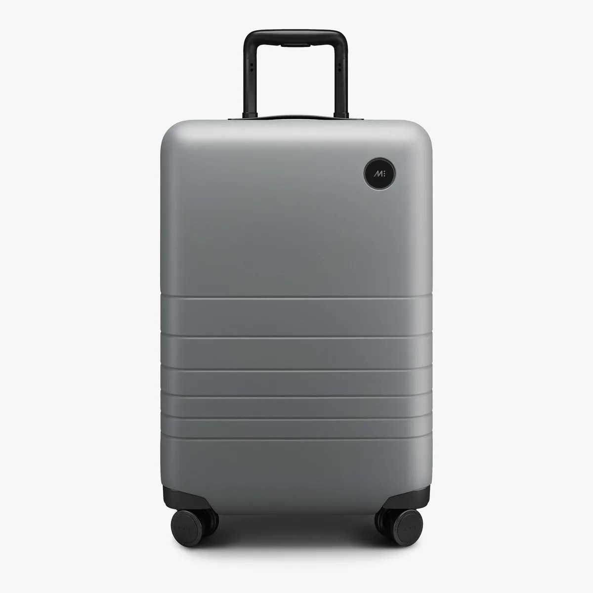 Gray hard-shell suitcase with black telescoping handle and four black wheels.