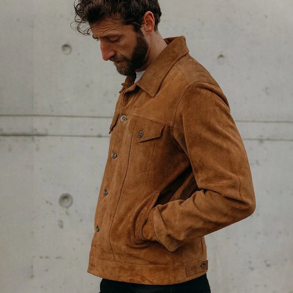 Man wearing a brown suede button-up jacket with flap chest pockets and side pockets.