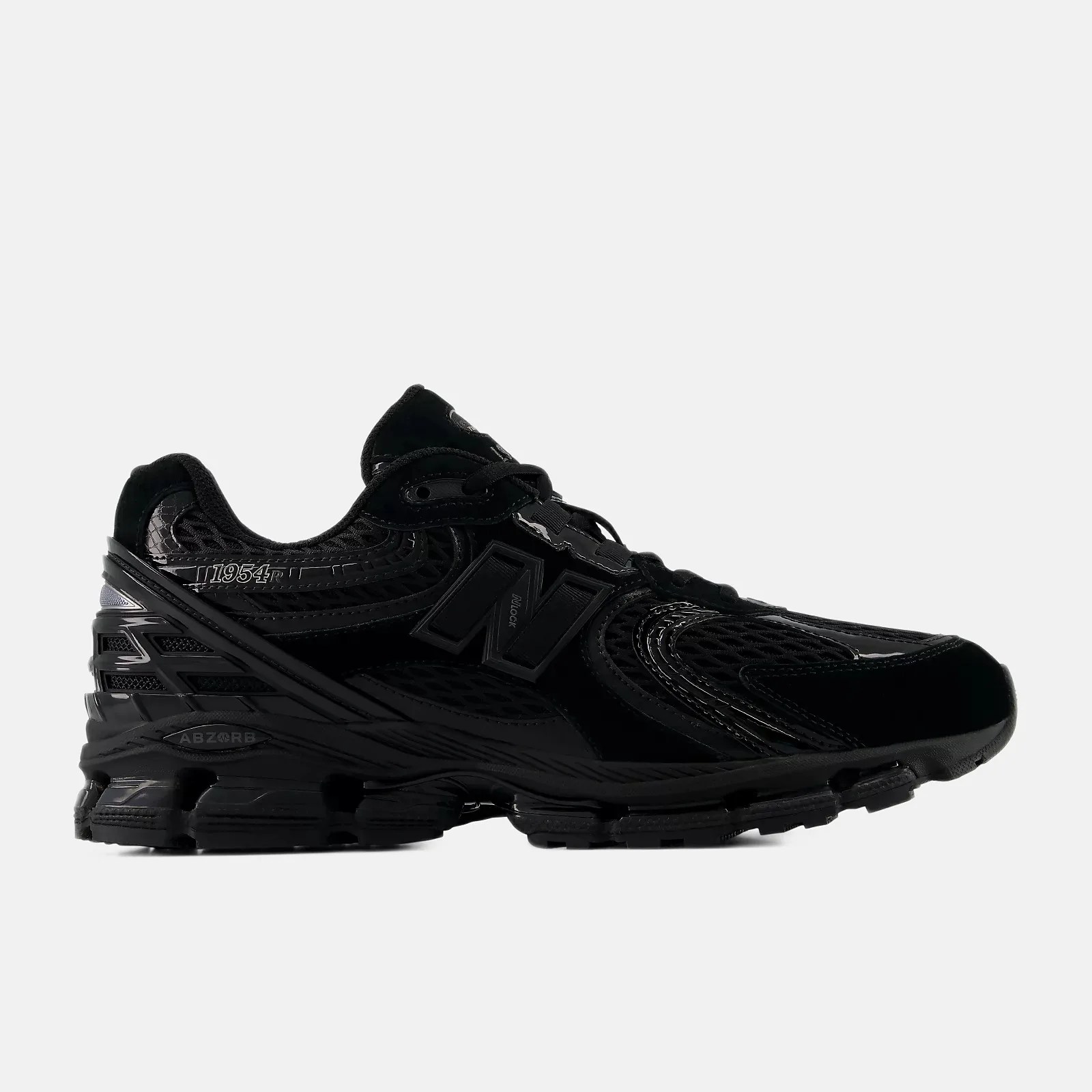 Black New Balance 1954 running shoe with mesh and synthetic upper and ABZORB cushioning sole.