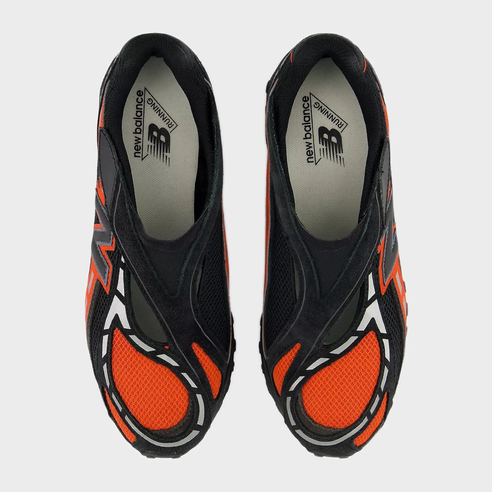 Pair of black and orange New Balance running shoes viewed from above.