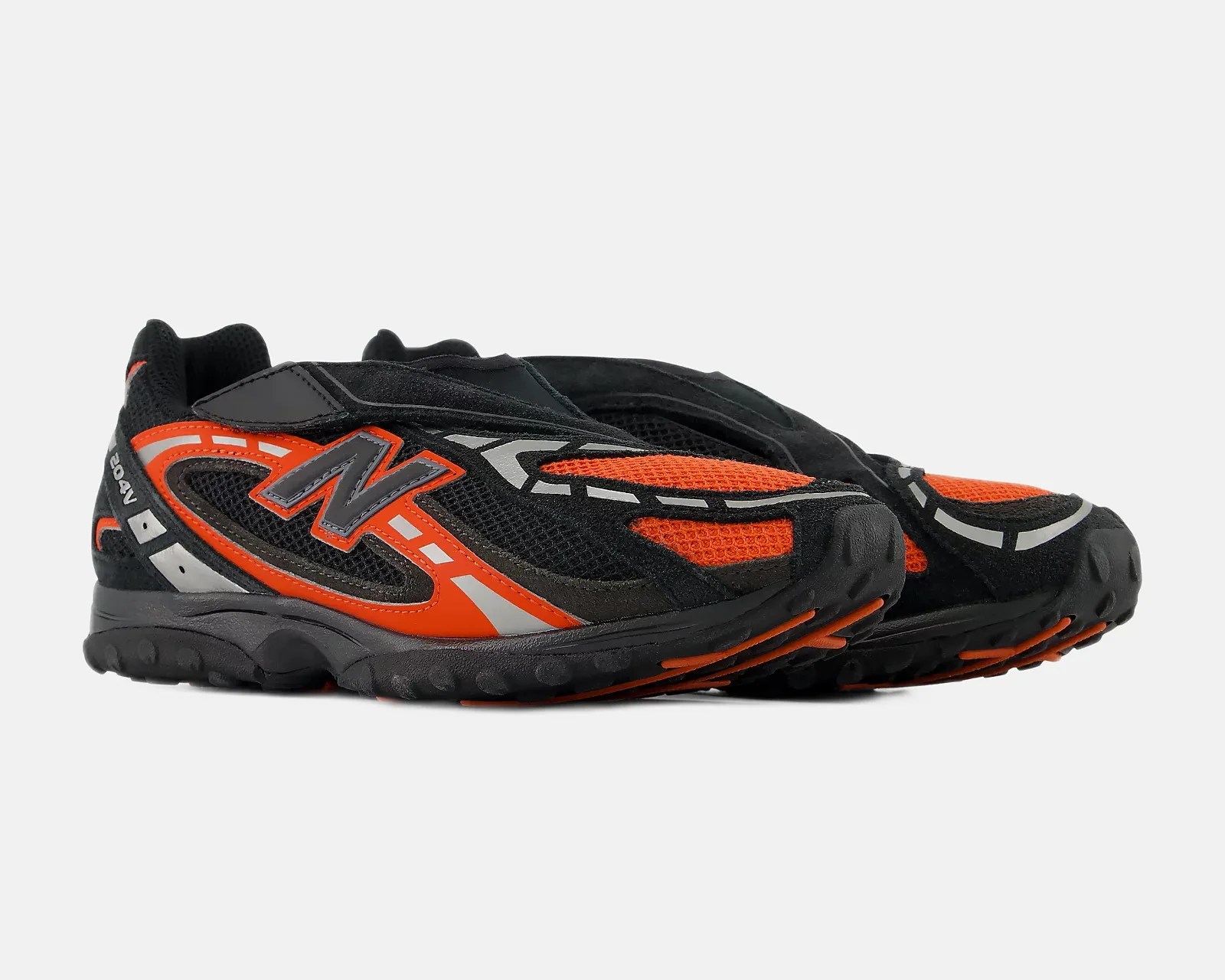 Pair of black and orange New Balance running shoes with mesh and synthetic overlays and reflective details.