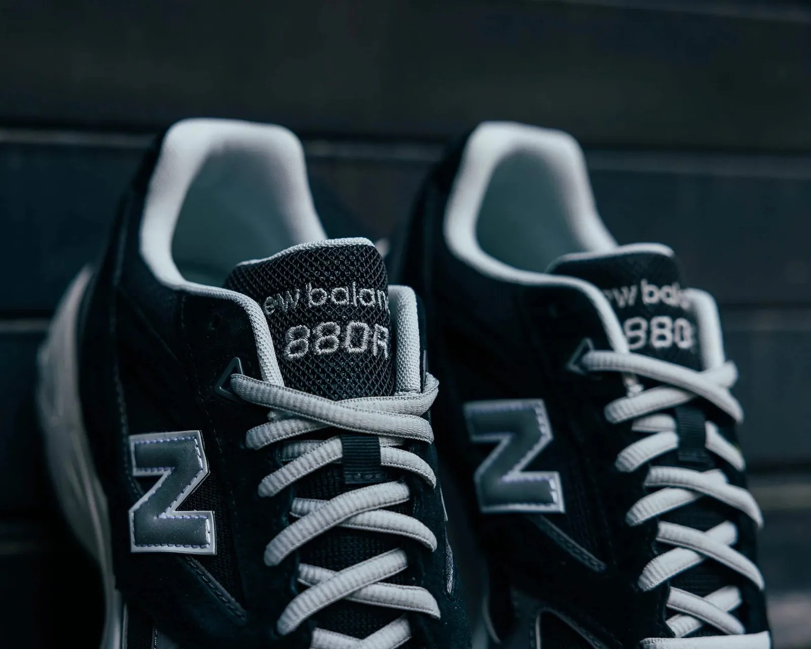 Pair of black New Balance 880R sneakers with white laces and gray "N" logos.