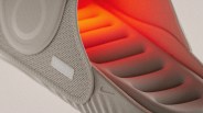 Close-up of a beige Nike shoe sole with textured grip and orange cushioning visible inside.