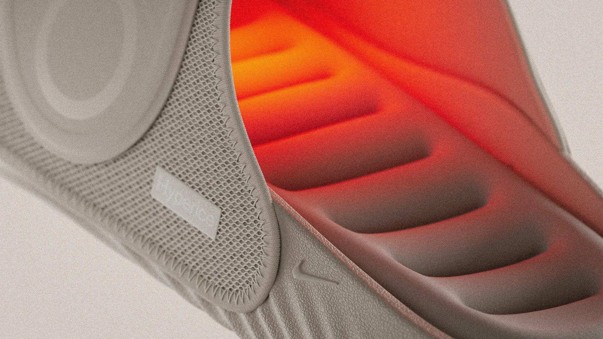 Close-up of a beige Nike shoe sole with textured grip and orange cushioning visible inside.