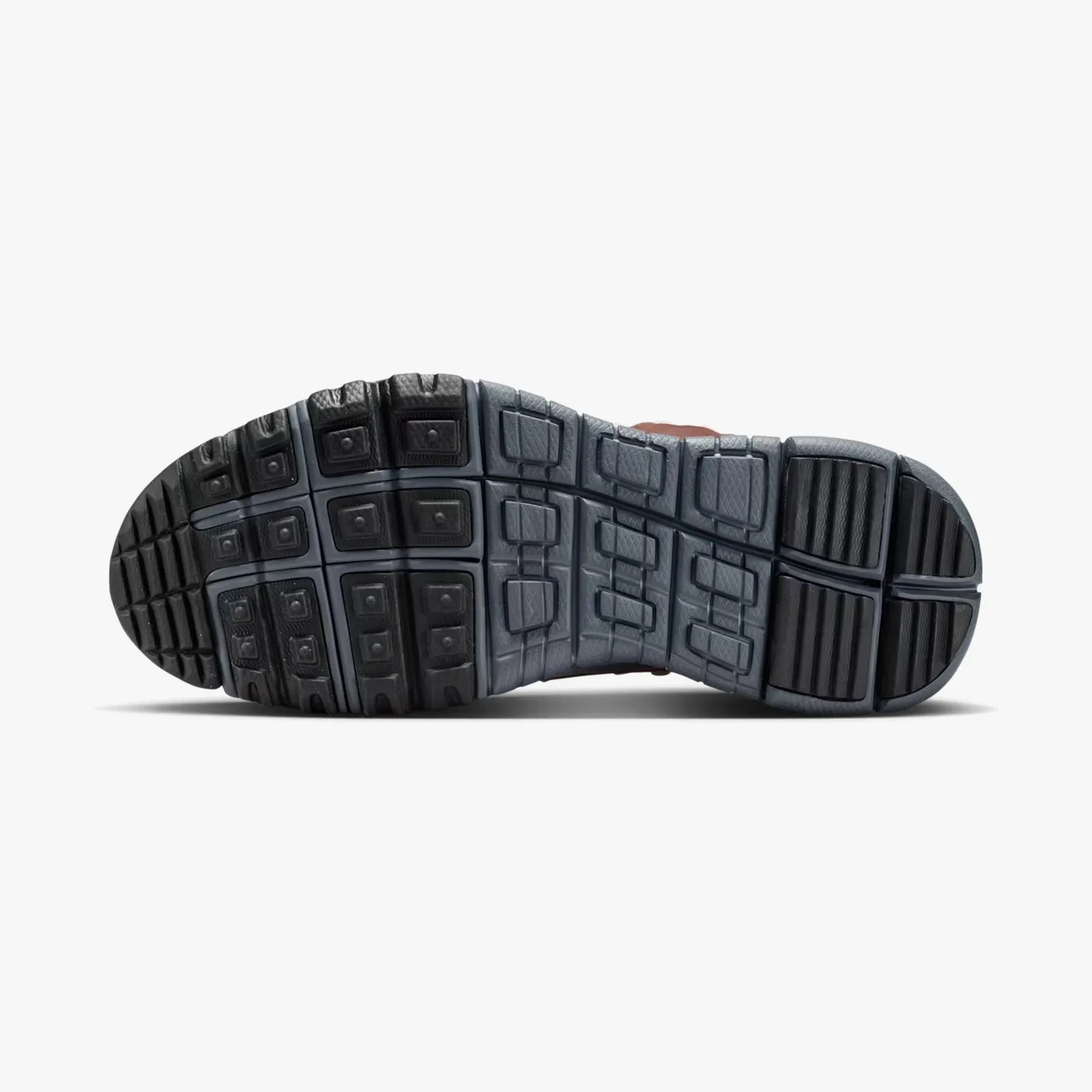 Black and gray segmented rubber outsole of a shoe with textured grip patterns.