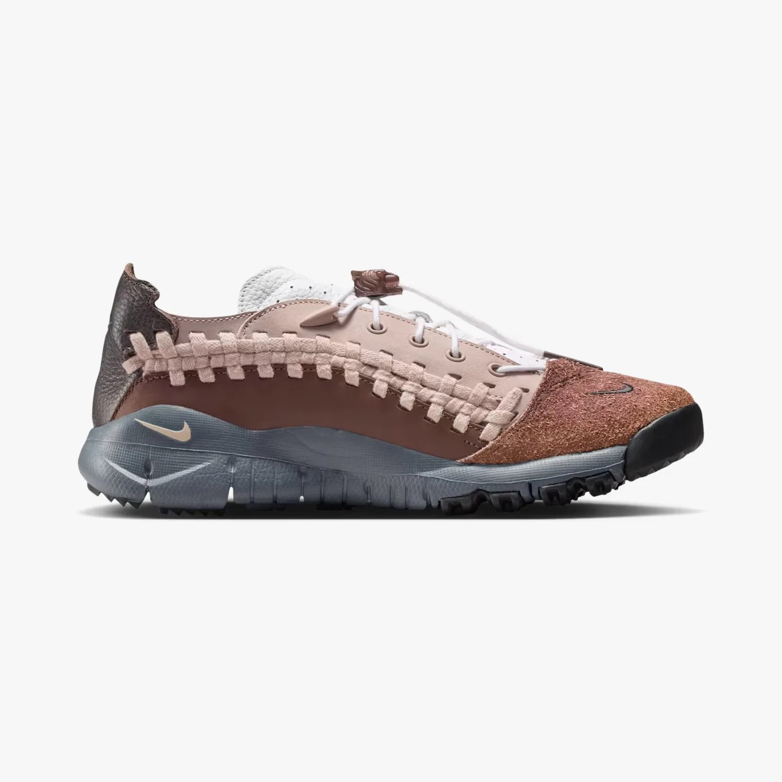 Brown and beige Nike sneaker with woven side detail, textured toe, and gray sole.