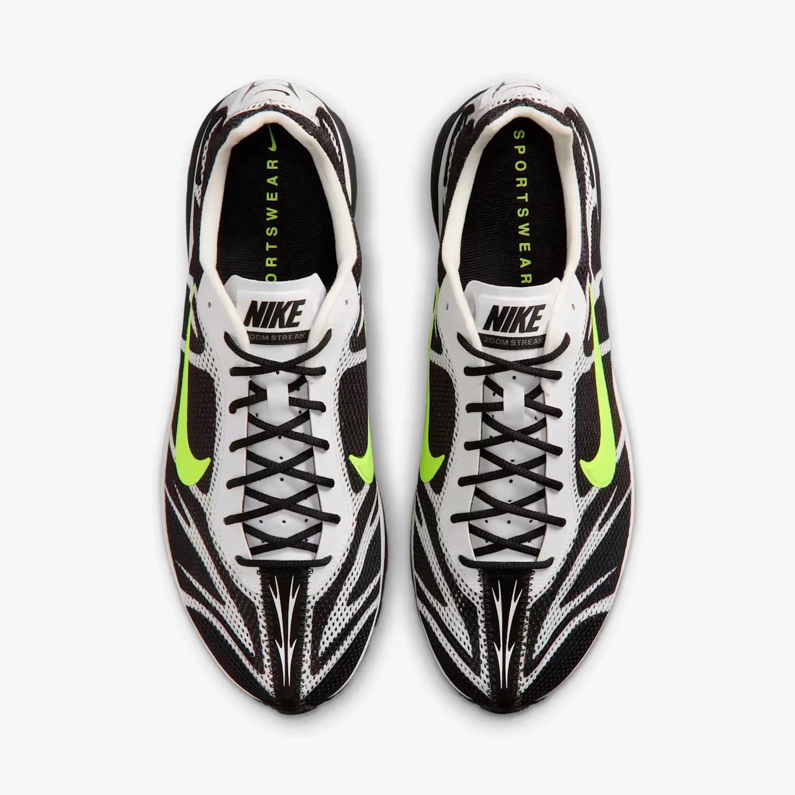 Pair of black and white Nike Zoom Streak running shoes with neon green swoosh logos, viewed from above.