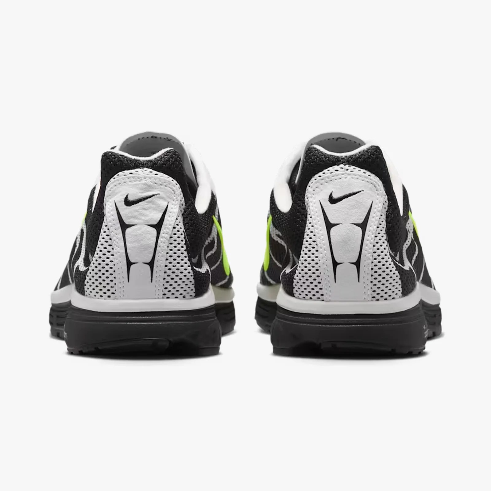 Pair of black and white Nike running shoes with neon green swoosh logos, viewed from the back.