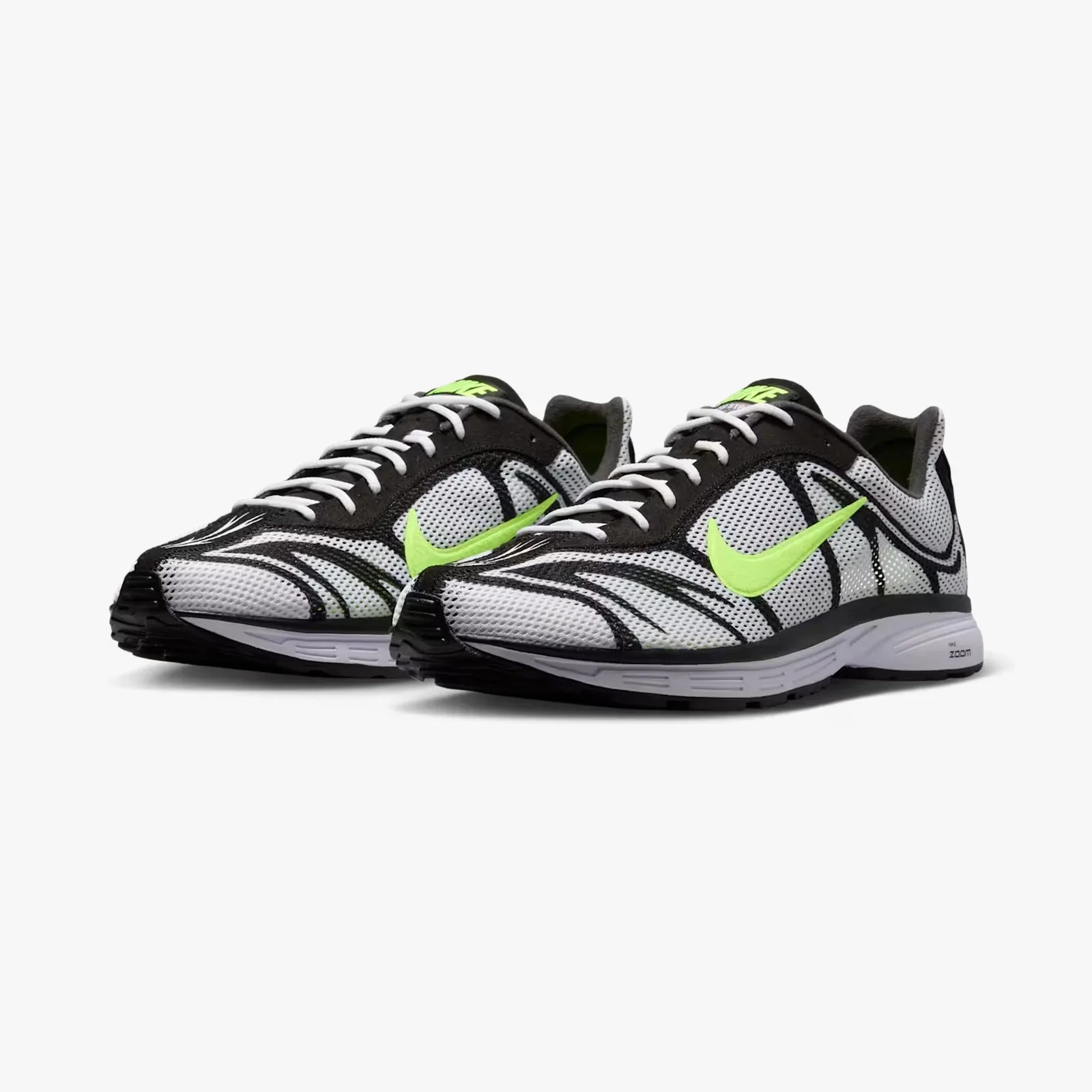 Pair of white and black Nike running shoes with neon green swoosh logos and white laces.