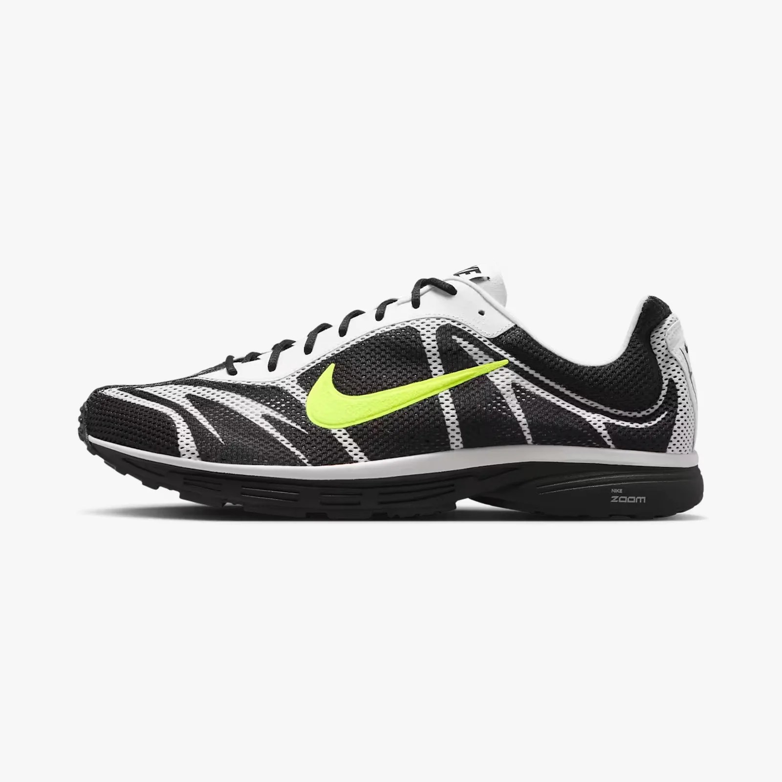 Black and white Nike Zoom running shoe with neon yellow swoosh and black sole.