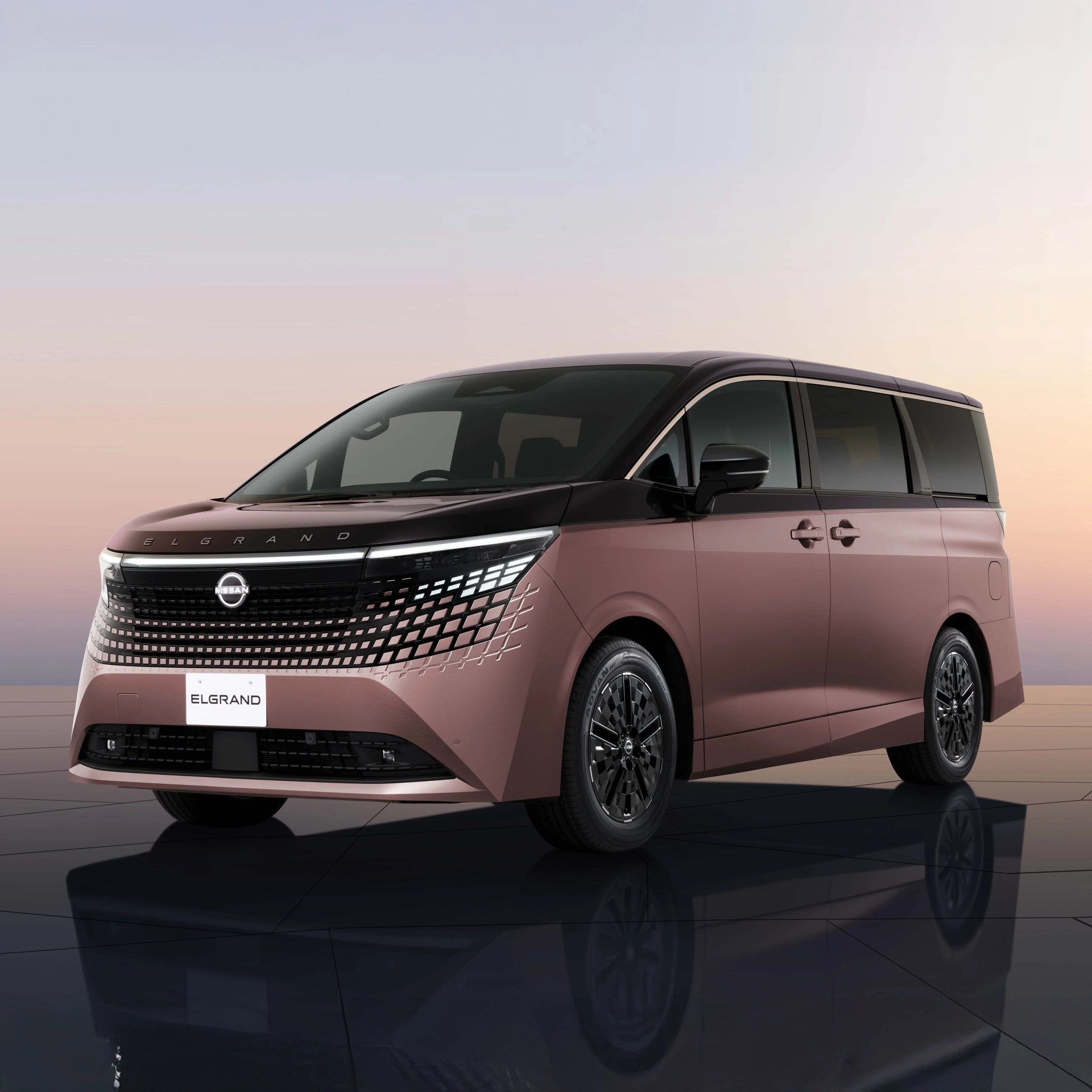 Two-tone pink and black Nissan Elgrand minivan with digital-patterned front grille and LED headlights.