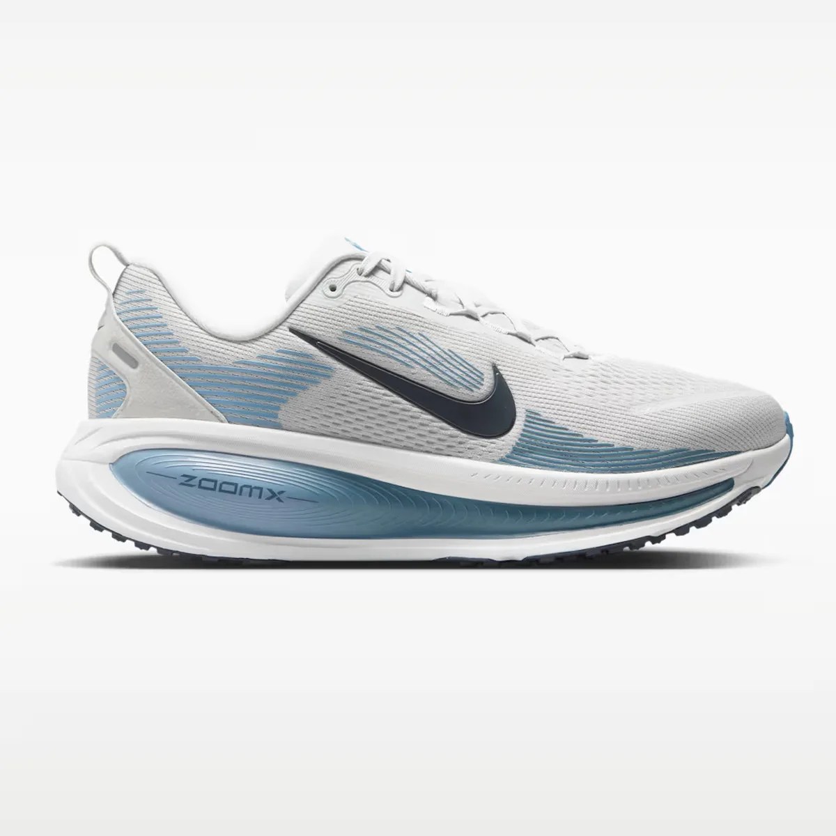 White and light blue Nike ZoomX running shoe with black swoosh logo and cushioned sole.