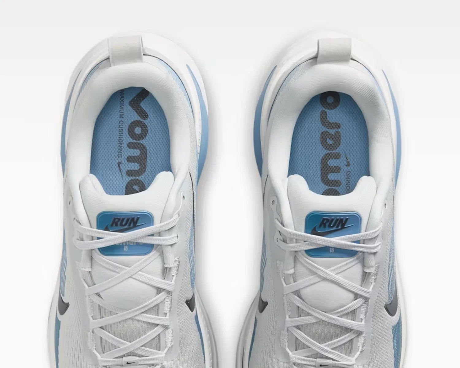 Pair of white and light blue Nike running shoes with "RUN" label on the tongue and blue insoles.