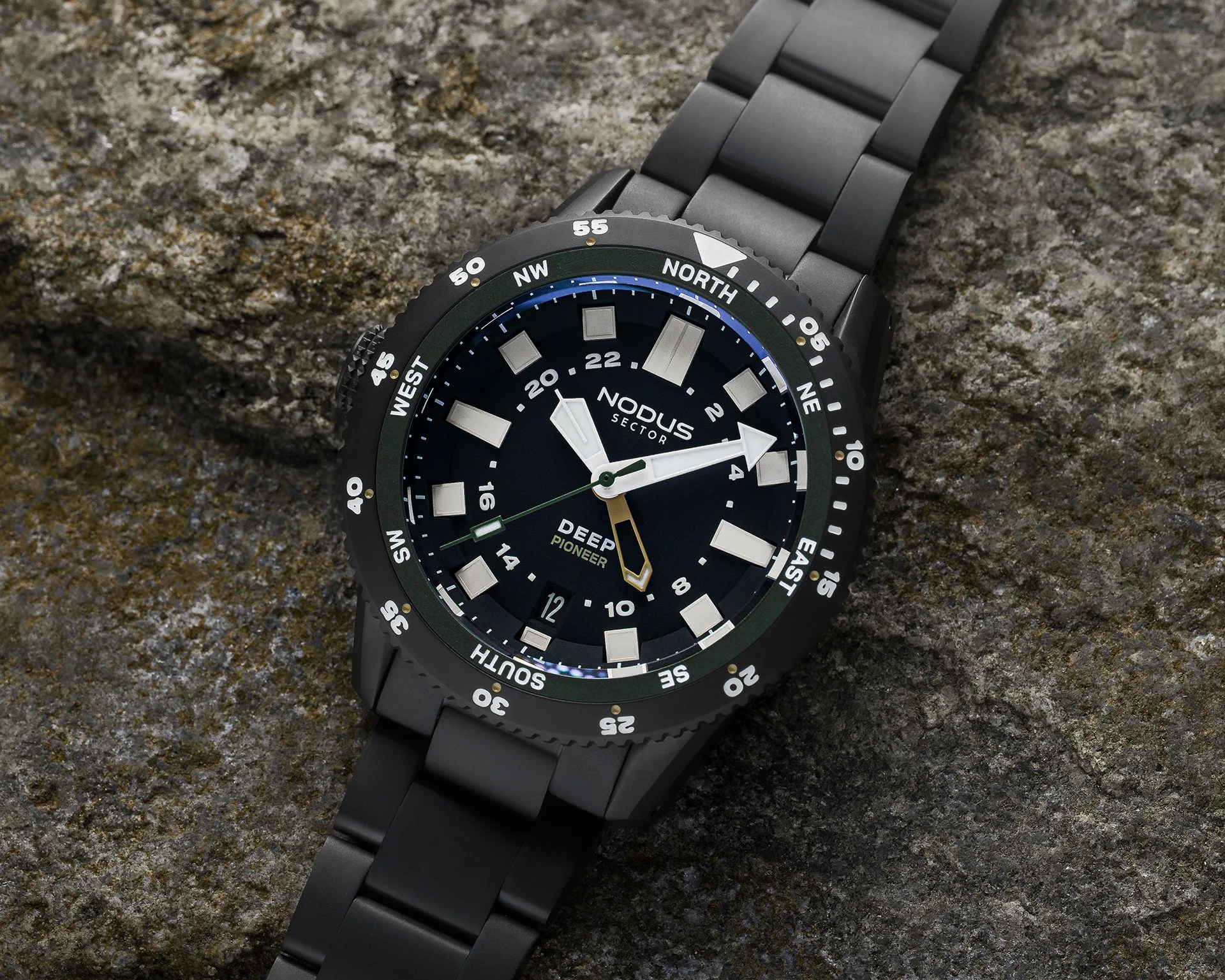 Black Nodus Sector Deep Pioneer wristwatch with white markers and hands on a textured stone surface.