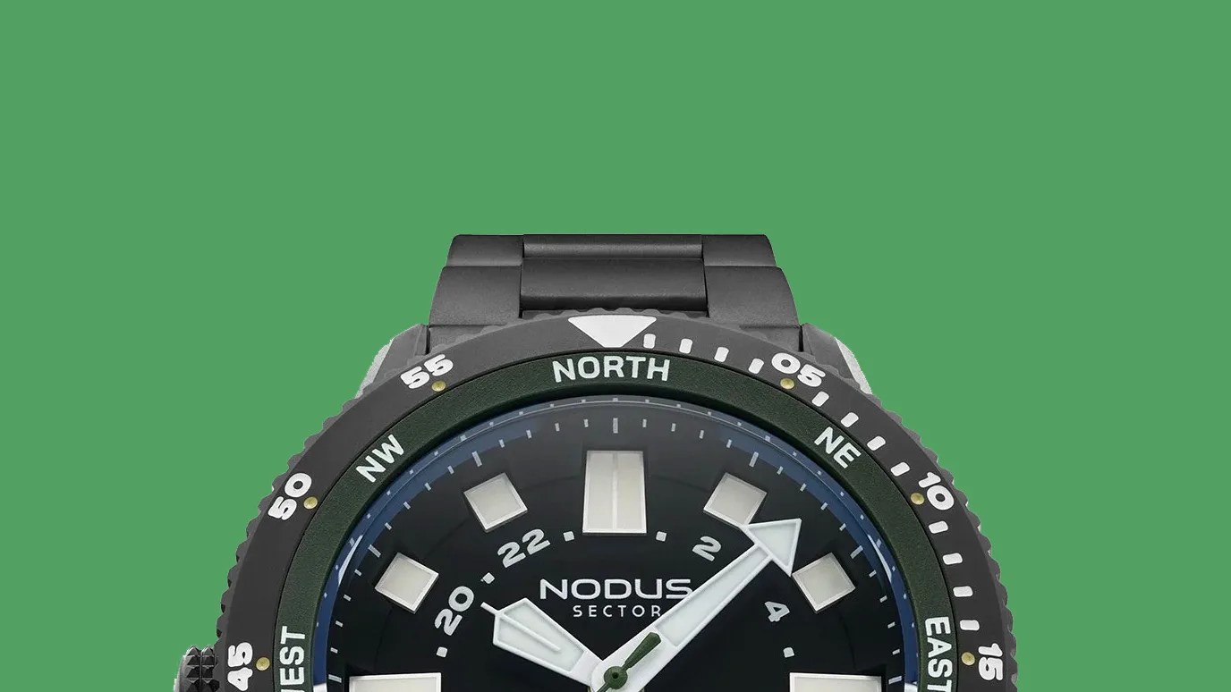 Black Nodus Sector wristwatch with white hour markers and compass bezel on a green background.