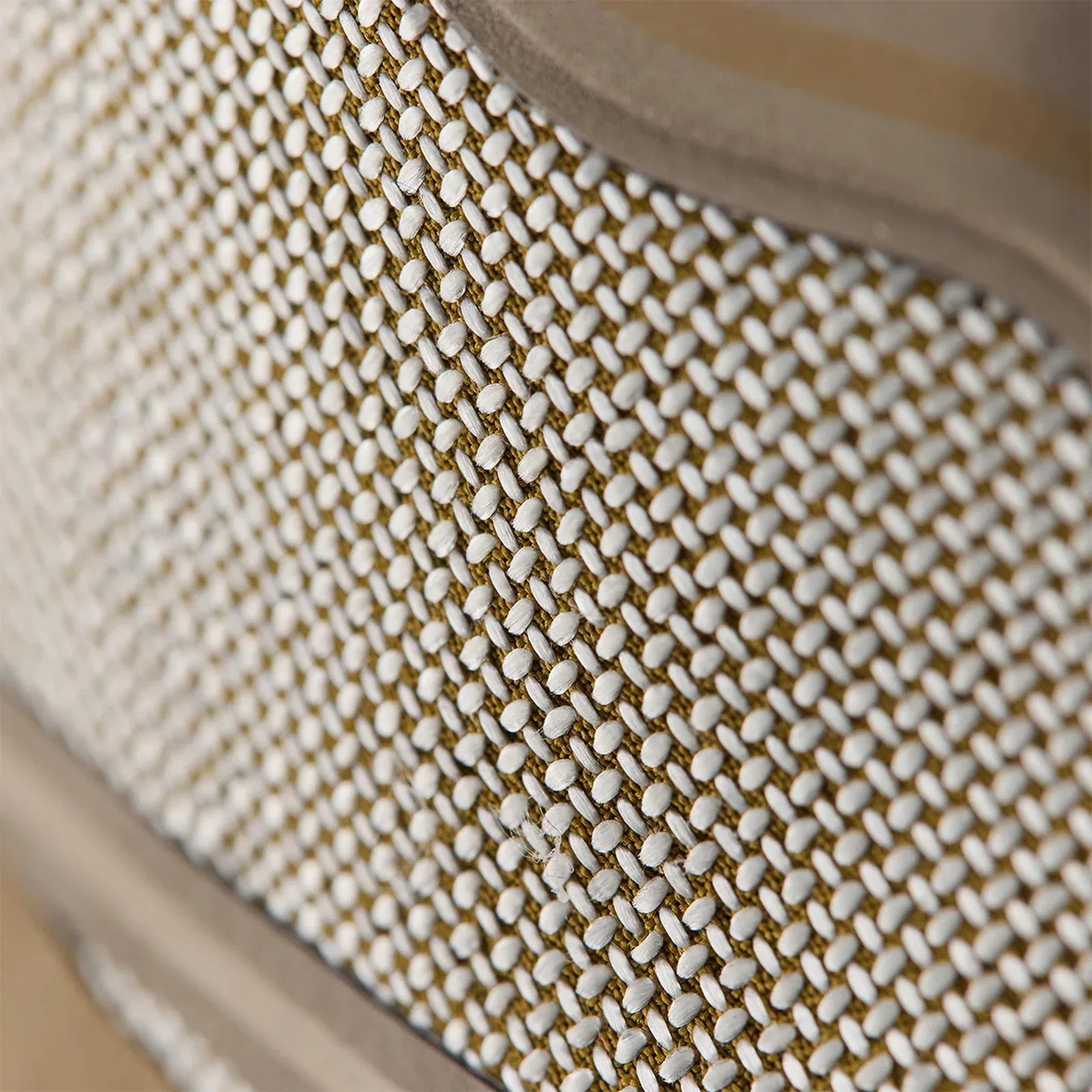 Close-up of beige and white woven fabric with a textured pattern and a smooth beige border.