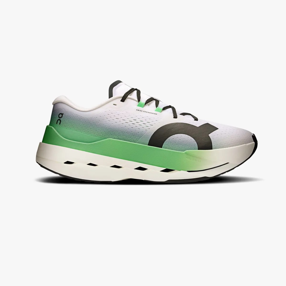White and green gradient running shoe with black laces and large black logo on the side.