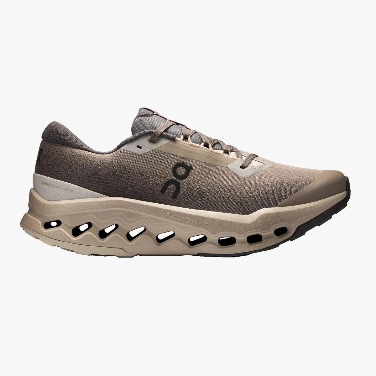 Beige and taupe running shoe with black logo and ventilated sole.