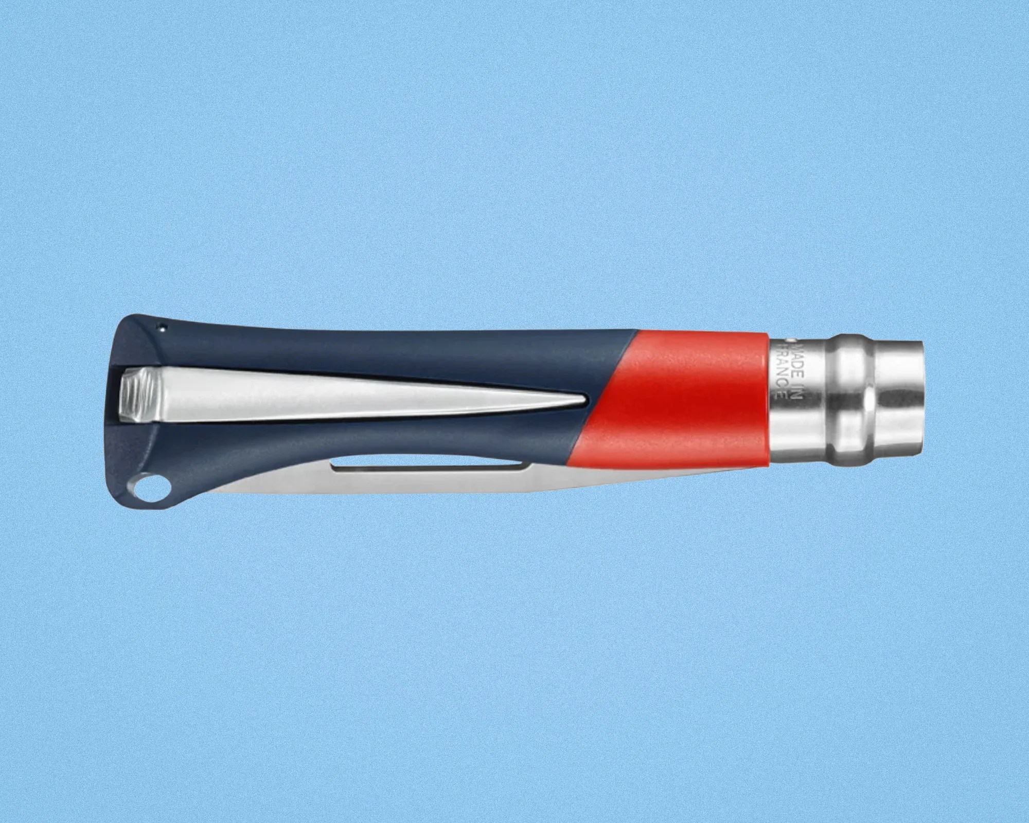 Blue and red folding knife handle with a metal clip and "Made in France" engraving on the metal part.