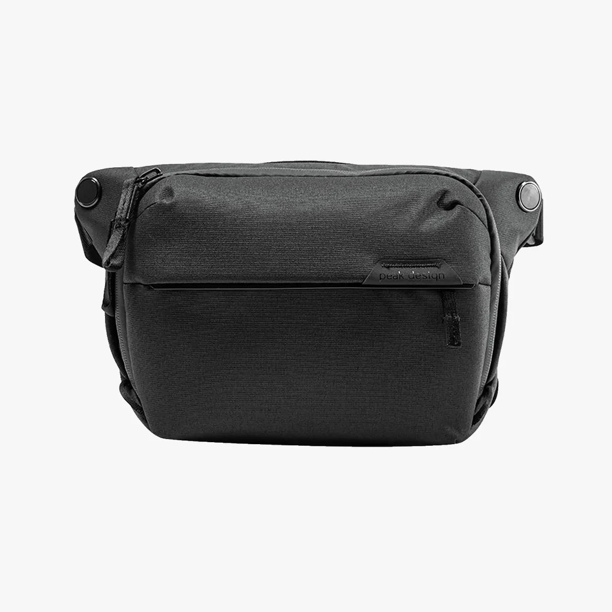 Black rectangular fabric waist bag with front zipper pocket and magnetic button closures.