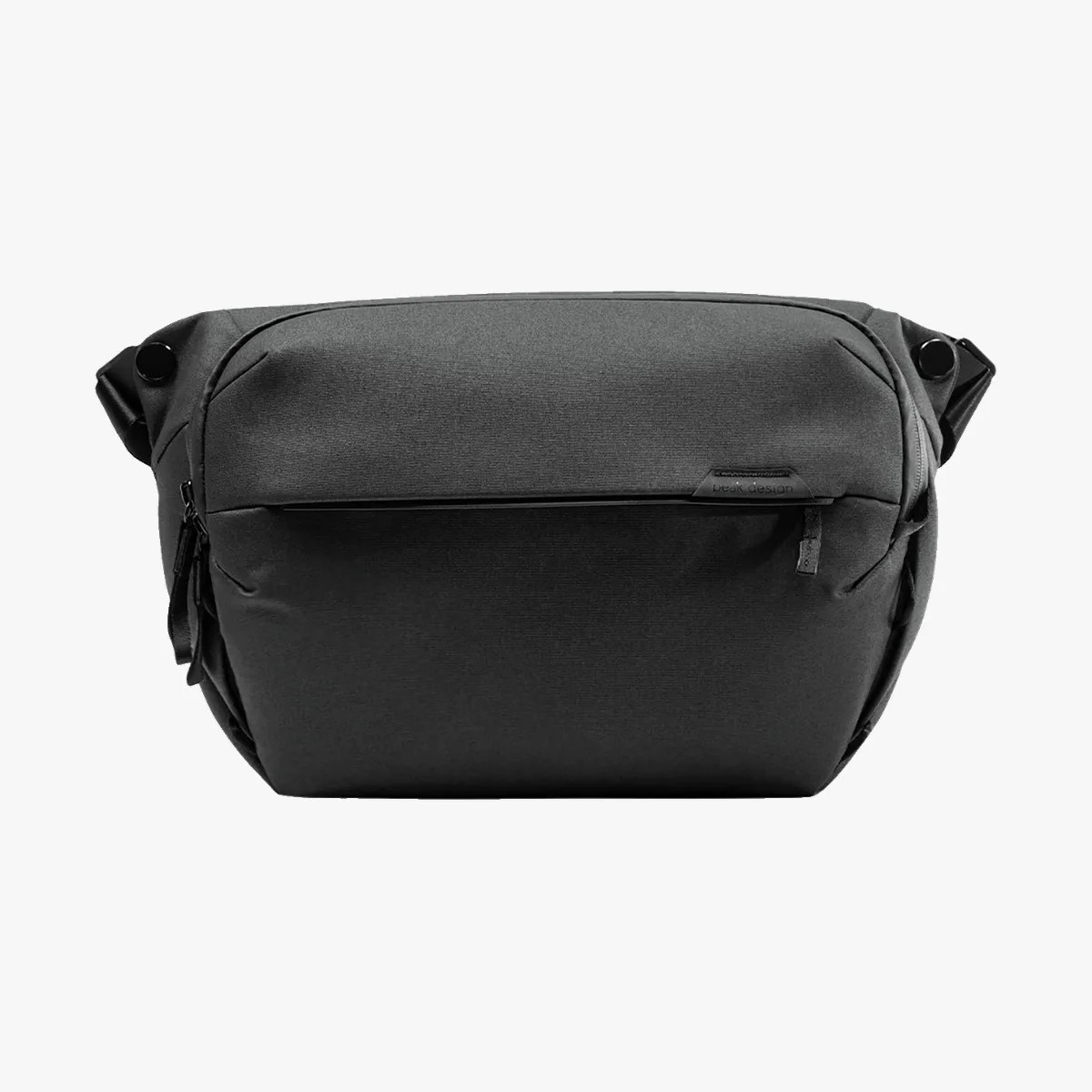 Black compact crossbody bag with a front zipper pocket and a smooth fabric finish.