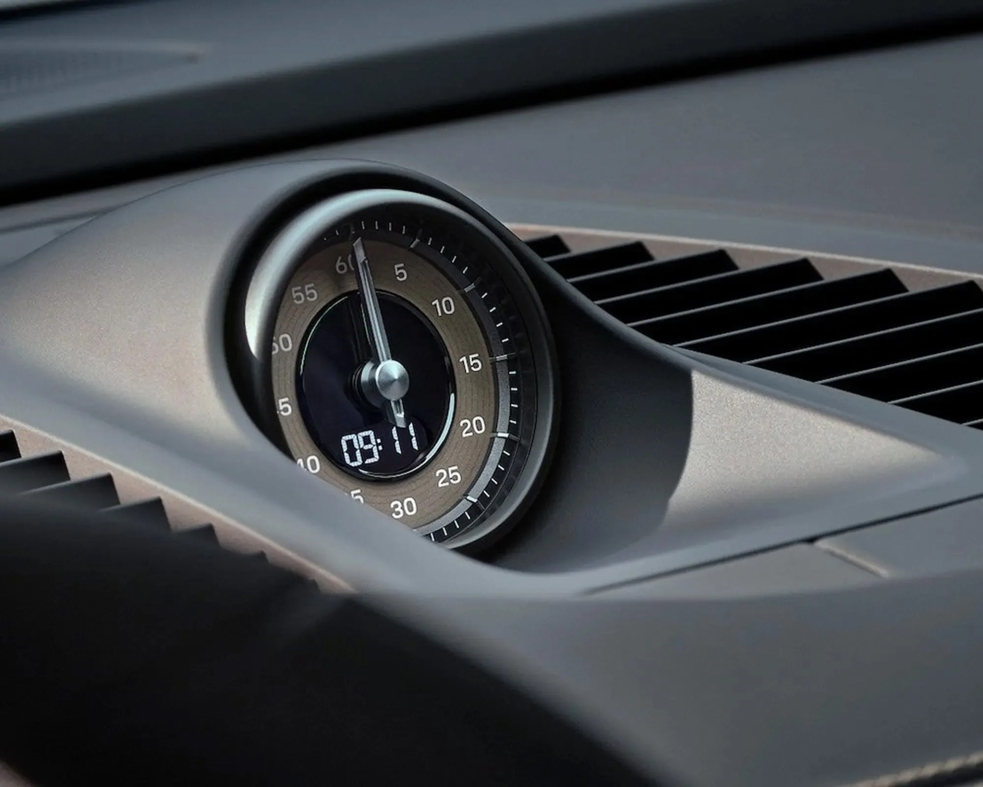 Round analog clock with digital time display set to 09:11 on a car dashboard.